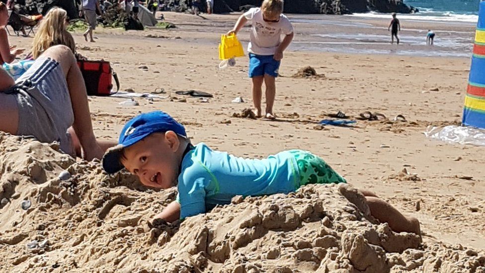 Harri, 2, playing in the sand