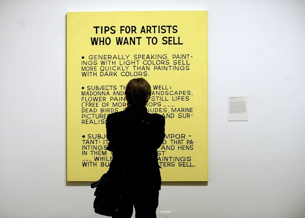 A visitor looks at Baldessari's Tips For Artists Who Want to Sell
