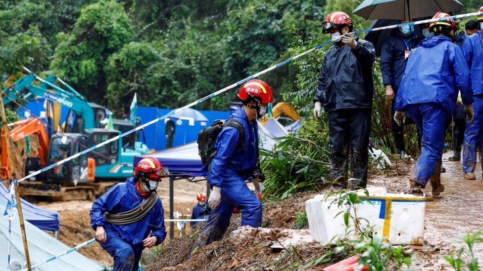 Rescue workers work at the plane crash site in Guangxi, China on 24 March