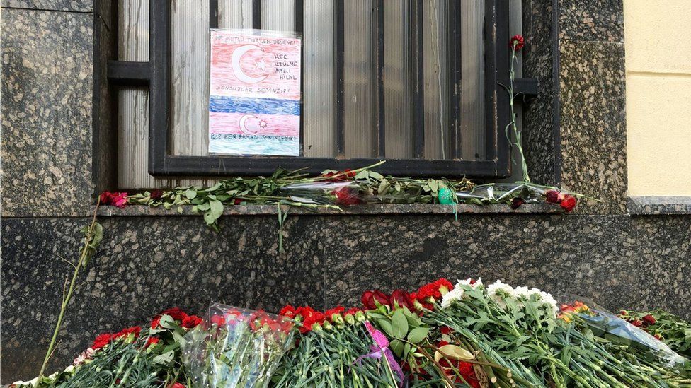 Outside the Turkish Embassy in Moscow there's a heap of flowers and a hand-coloured paper flag.