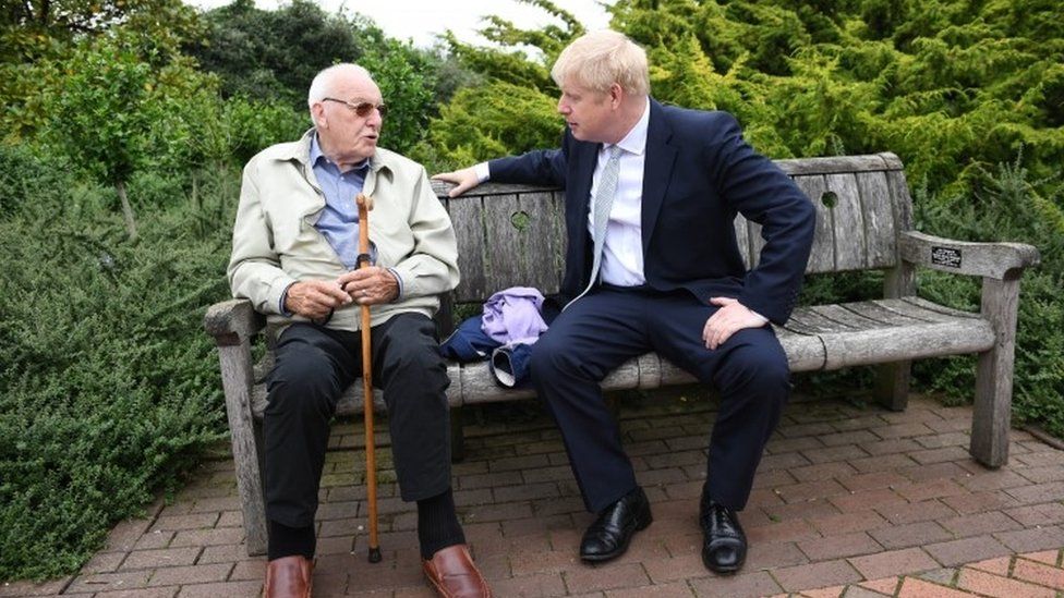Boris Johnson speaking to a pensioner at Wisley