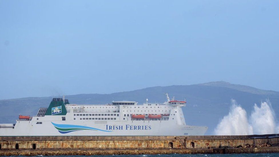 Strong winds cause the waves to hit the breakwater at Holyhead as the Irish Ferries ship Isle of Inishmore pulls into the harbour on the Island of Anglesey in Wales
