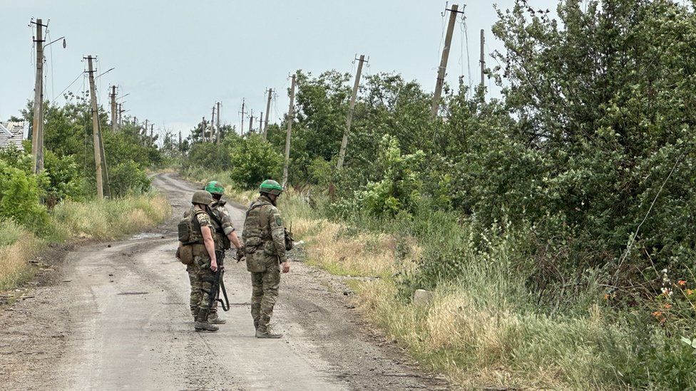 Ukrainian troops inspecting mined roads