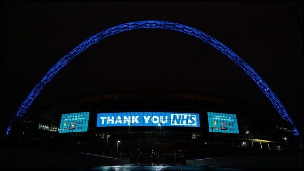Wembley Stadium Arch in London lit up in blue