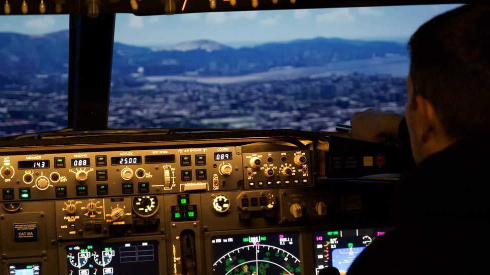 Person sitting in flight simulator