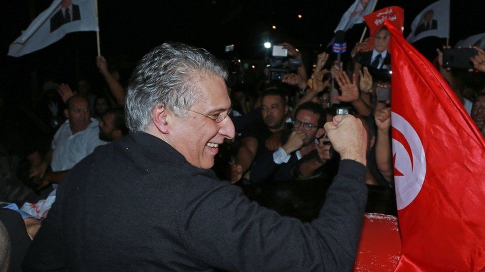 Nabil Karoui greets his supporters after being released from Mornaguia prison near the capital Tunis on 9 October