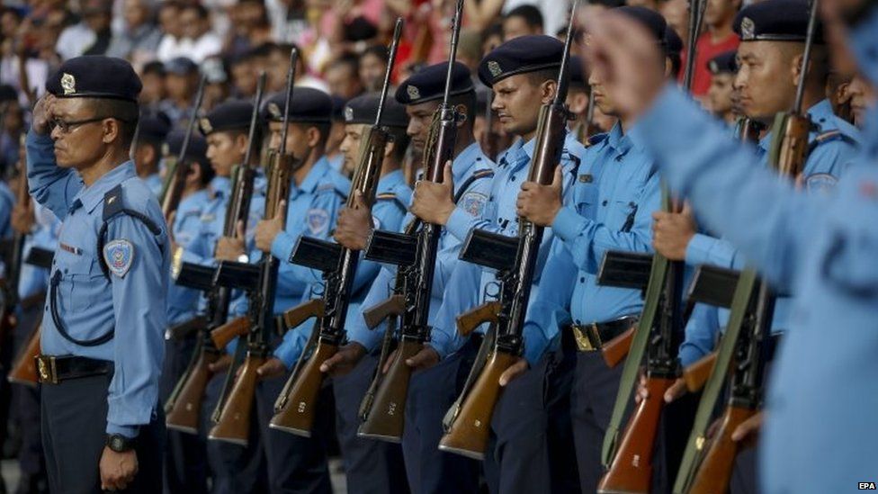 Nepalese police soldiers stand to attention during the funeral of killed Senior Superintendent of Police Laxman Neupane at a cremation centre, in Kathmandu, Nepal, 25 August 2015