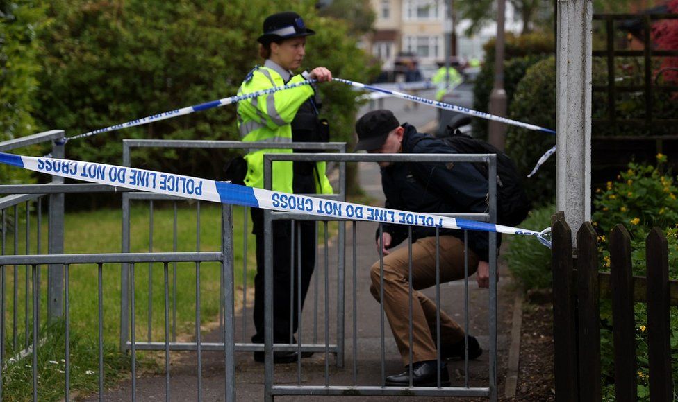 Man being let through cordon by police officer