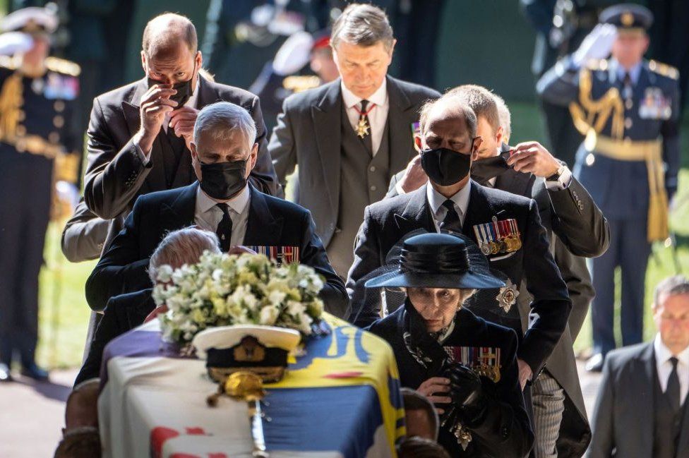 Members of the royal family follow the coffin into St George's Chapel