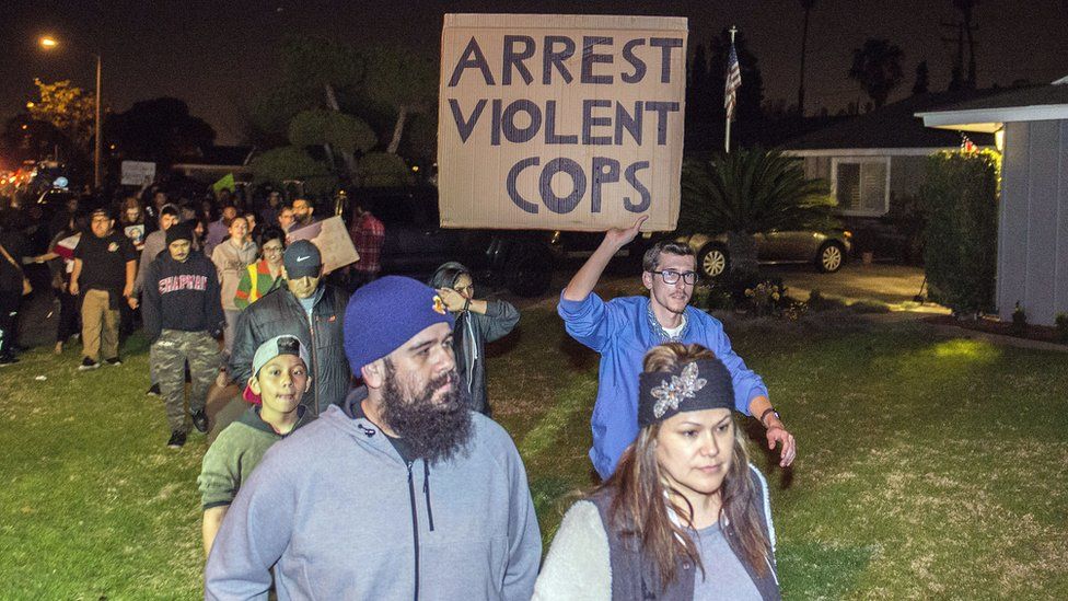 Protesters march towards the off-duty officer's home in Anaheim, California