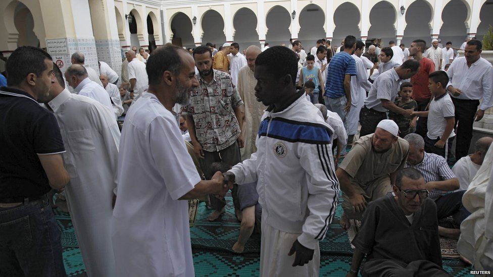 Worshippers congratulate each other after morning prayers of Eid al-Fitr holiday, marking the end of the holy month of Ramadan, at al-Biar mosque in Algiers, Algeria on Friday