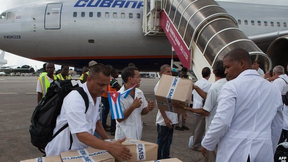 The first members of a team of 165 Cuban doctors and health workers upon their arrival at Freetown's airport to help the fight against Ebola in Sierra Leone, on 2 October, 2014.