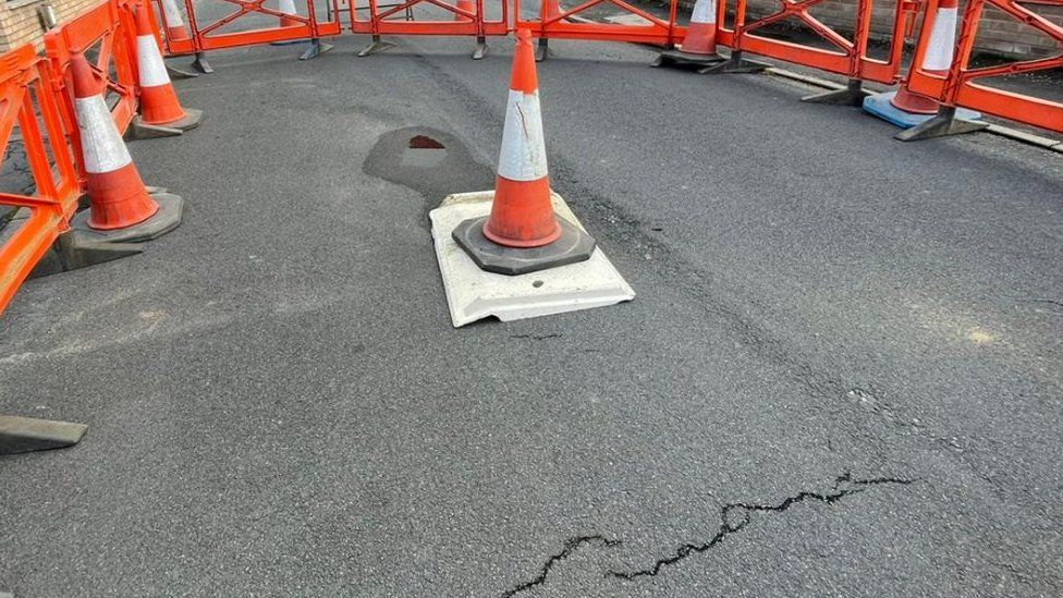 Traffic cone over sinkhole