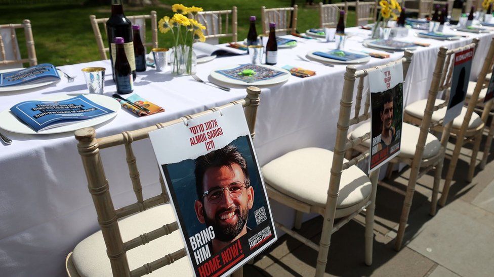 An empty Seder table paying homage to Israeli hostages still held by Hamas in Gaza sits along Whitehall in London (17 April 2024)