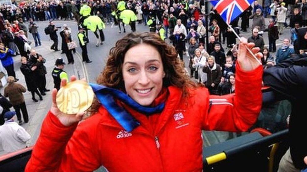 Amy Williams holding her gold medal