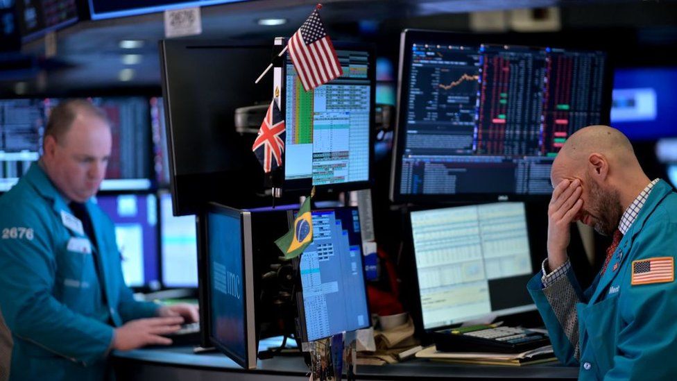 Trader with his head in his hand at the New York Stock Exchange