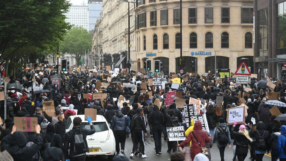 People marching down Colmore Row during a Black Lives Matter protest rally in Birmingham