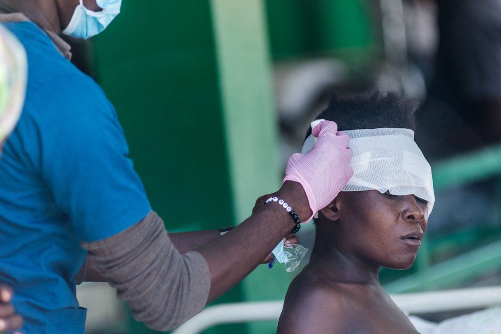 An injured woman is treated at a hospital in Les Cayes on 15 August 2021