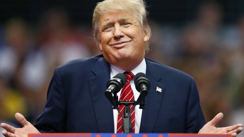 Donald Trump shrugs during a speech.