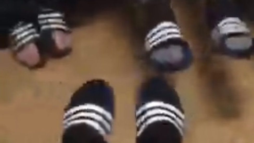 The men's feet in their flip flops