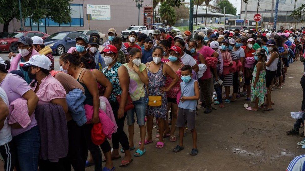 Migrants on the Mexican side of the border