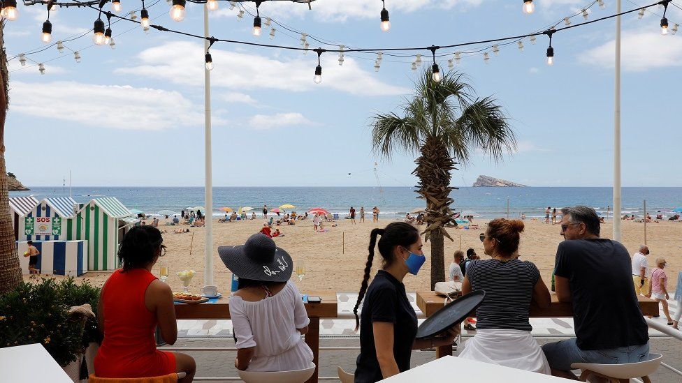People enjoy the weather on Levante beach in Benidorm, Spain, June 6, 2021.