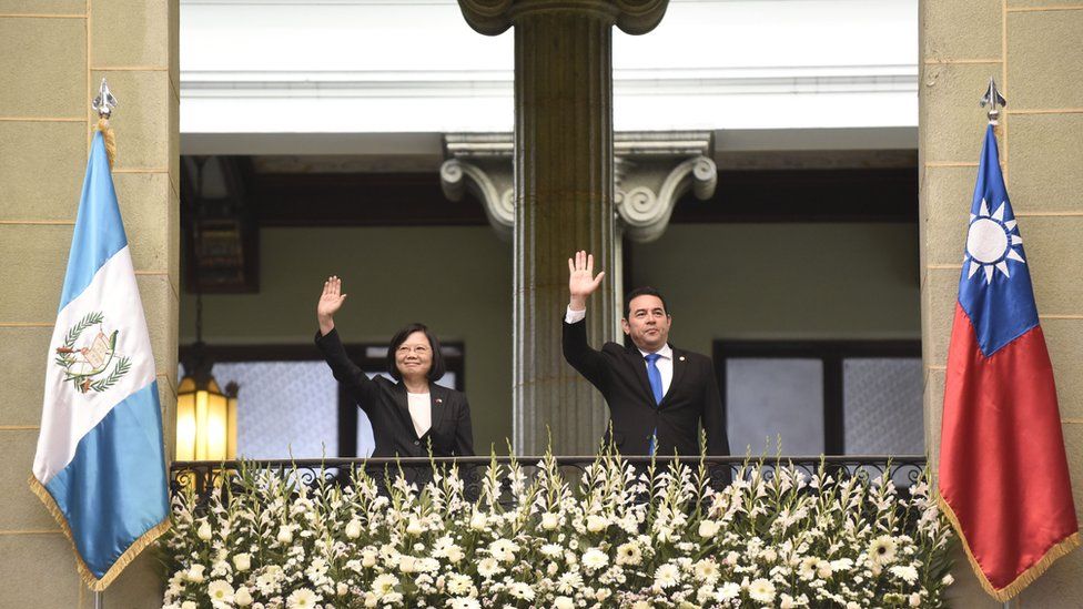 Taiwan's President Tsai Ing-wen (L) and Guatemalan President Jimmy Morales wave from a balcony at the Culture Palace in Guatemala City on January 11, 2017.