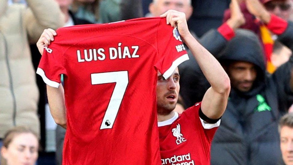 Liverpool's Diogo Jota holds up a shirt in support of Liverpool's Luis Diaz as he celebrates scoring their first goal