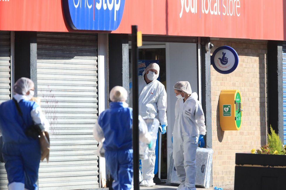 Forensics officers at the entrance to the One Stop Shop