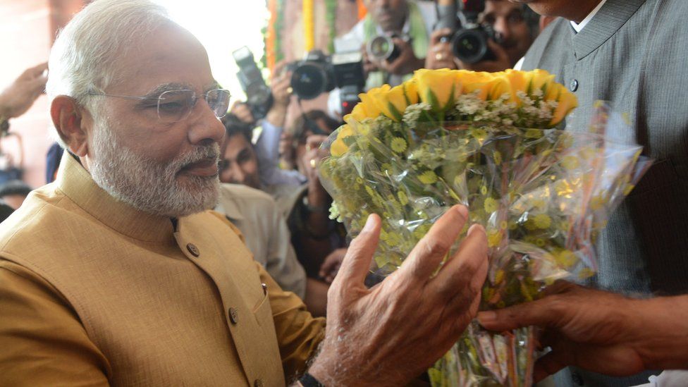 Narendran Modi receiving a bouquet