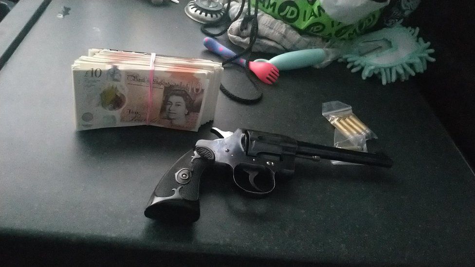a gun, cash and ammunition