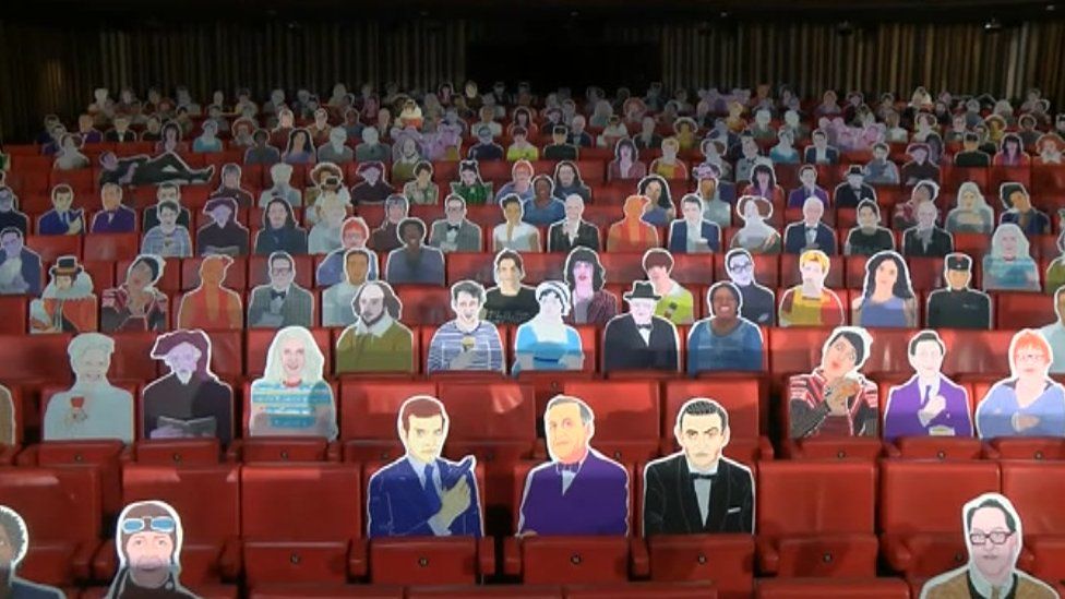 Cardboard cut out characters in theatre seats