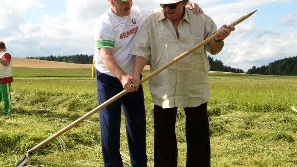President Alexander Lukashenko and French actor Gerard Depardieu (right) hold a hand scythe. Photo: 22 July 2015