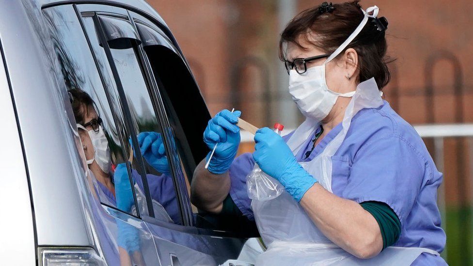 A member of the public is swabbed at a drive through coronavirus testing site in Wolverhampton