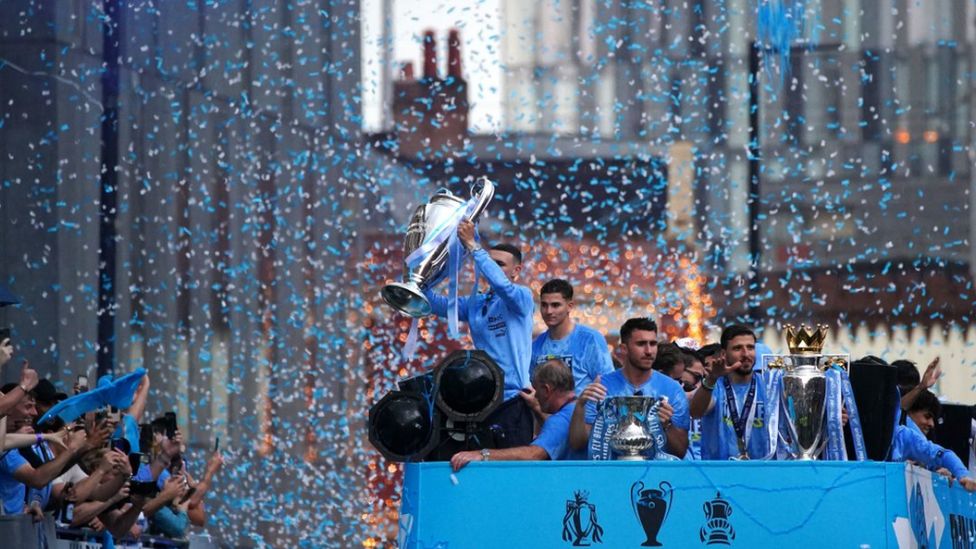 City players show off the three trophies