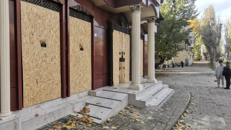 Boarded up shop in Kherson