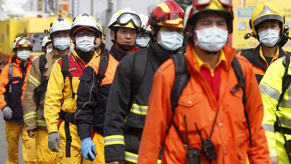 Rescuers in Tainan, Taiwan, on 6 February 2016