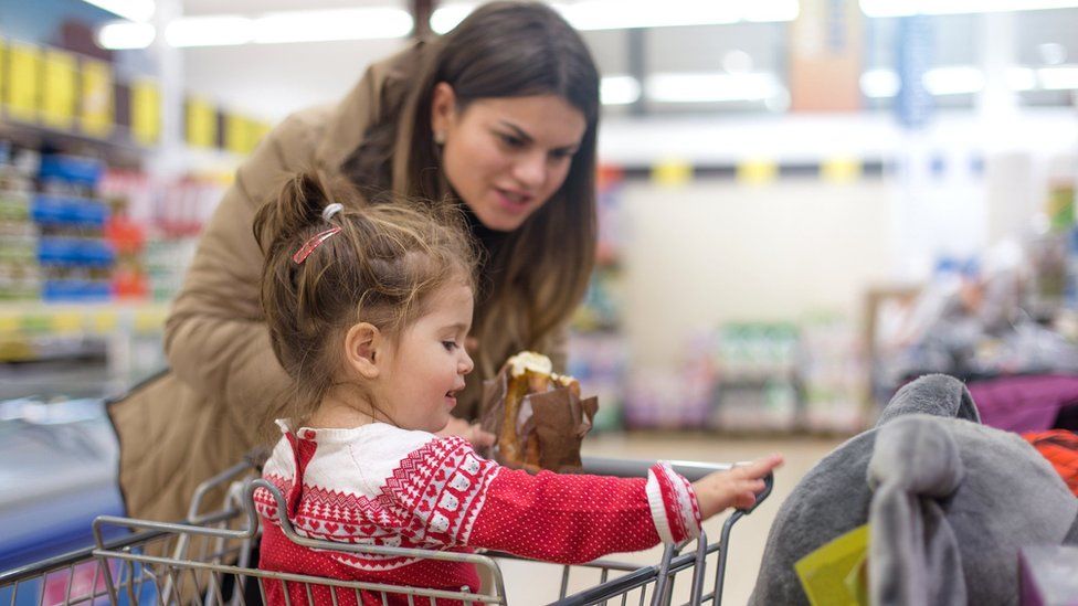Stock image of mother and daughter doing Christmas food shop.
