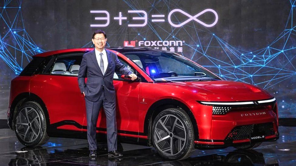 Foxconn chairman Young Liu with one of the company's electric cars.