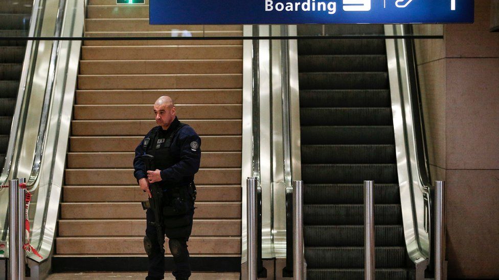 A riot police officer patrols inside Orly airport after the resumption of flights on 18 March