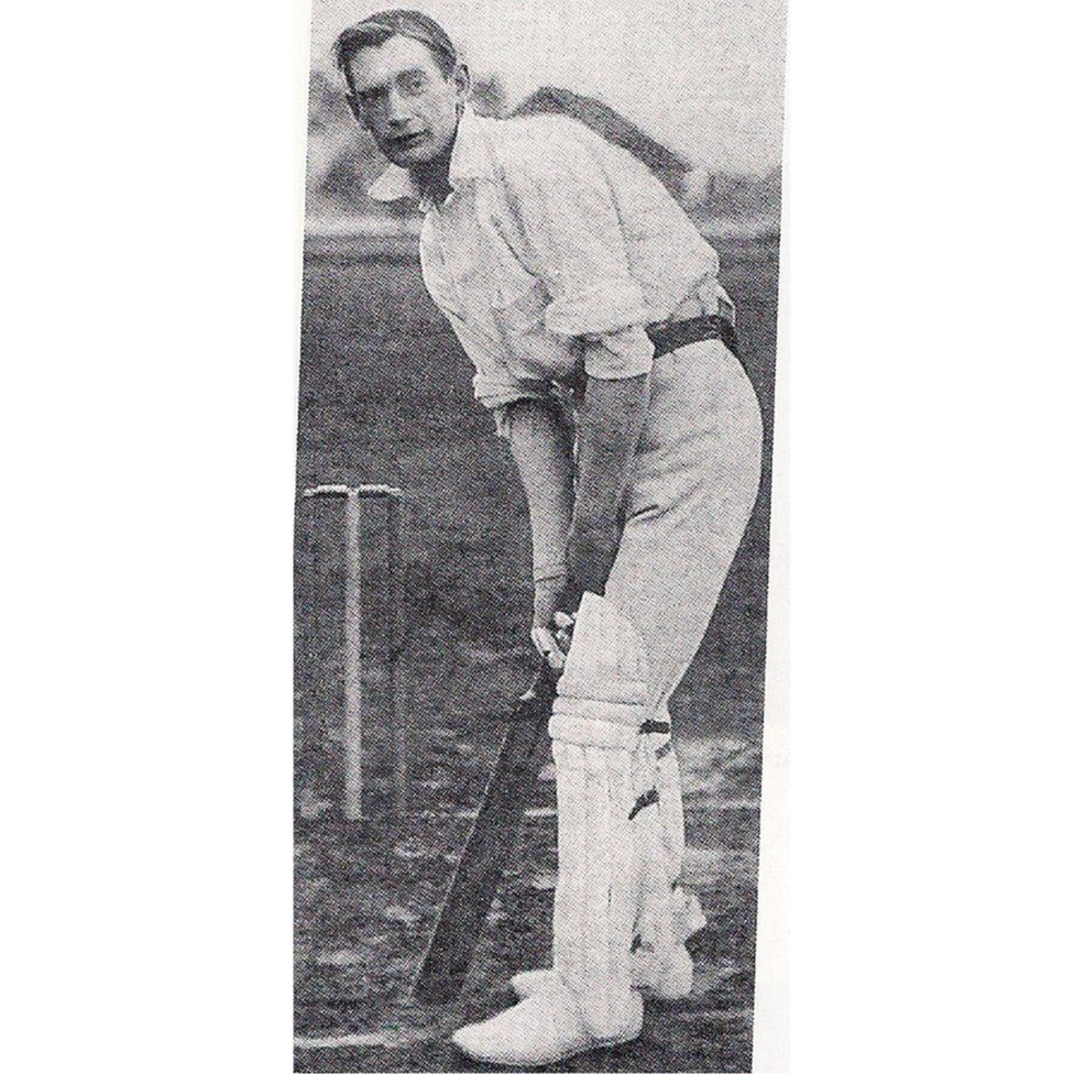 Percy Jeeves holding a bat in front of a wicket