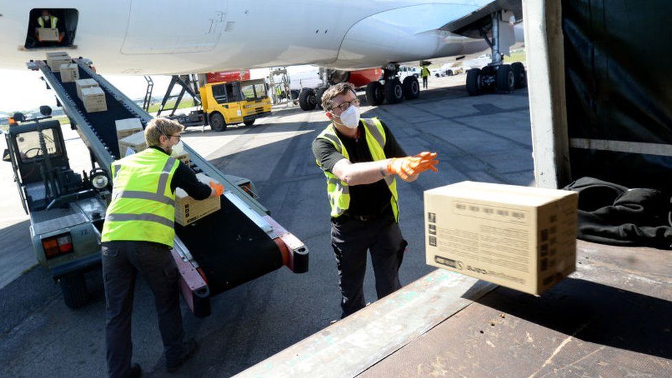 Workers loading cargo on a plane