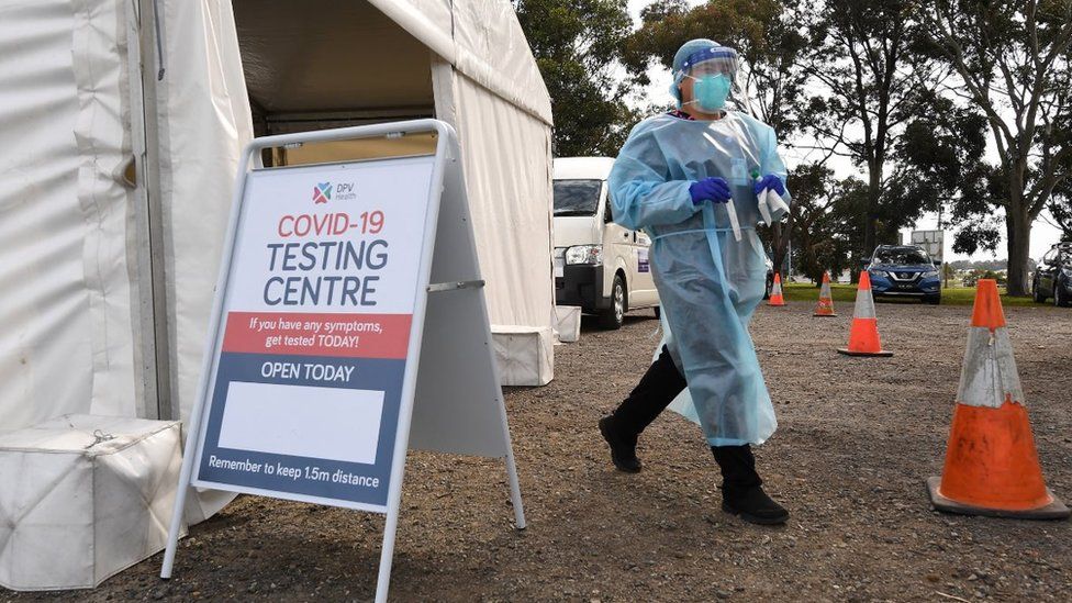 A healthcare working in protective gear works at a COVID-19 testing facility in Melbourne, Victoria, Australia, 18 September 2020