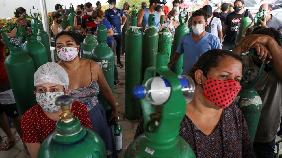 Relatives of patients hospitalised or receiving healthcare at home gather to buy oxygen and fill cylinders at a private company in Manaus