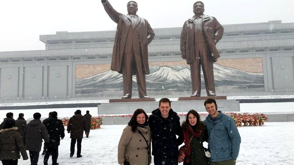 Otto Warmbier and friends pose in front of statues in North Korea