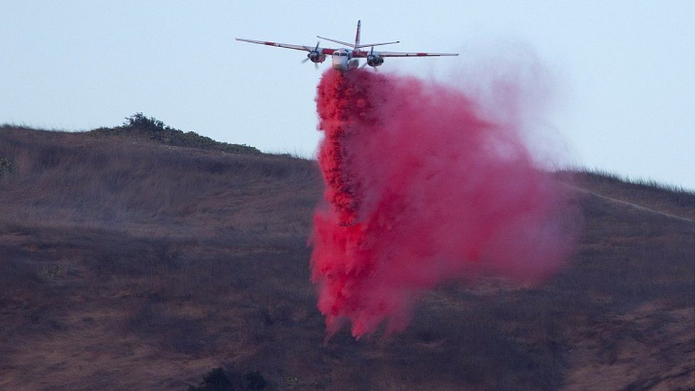 A plane makes a retardant drop on the Silverado Fire burns near Lake Forest, California, U.S., October 26, 2020