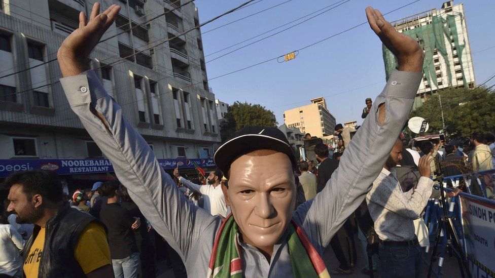A supporter of convicted former prime minister Imran Khan's Pakistan Tehrik-e-Insaf (PTI) political party wearing a mask depicting Khan takes part in a protest against alleged rigging in the general elections, outside the provincial election commission office in Karachi, Pakistan, 11 February 2024.