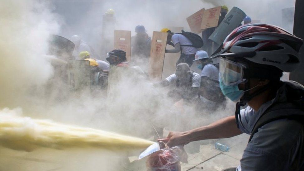 Protesters take cover in Yangon