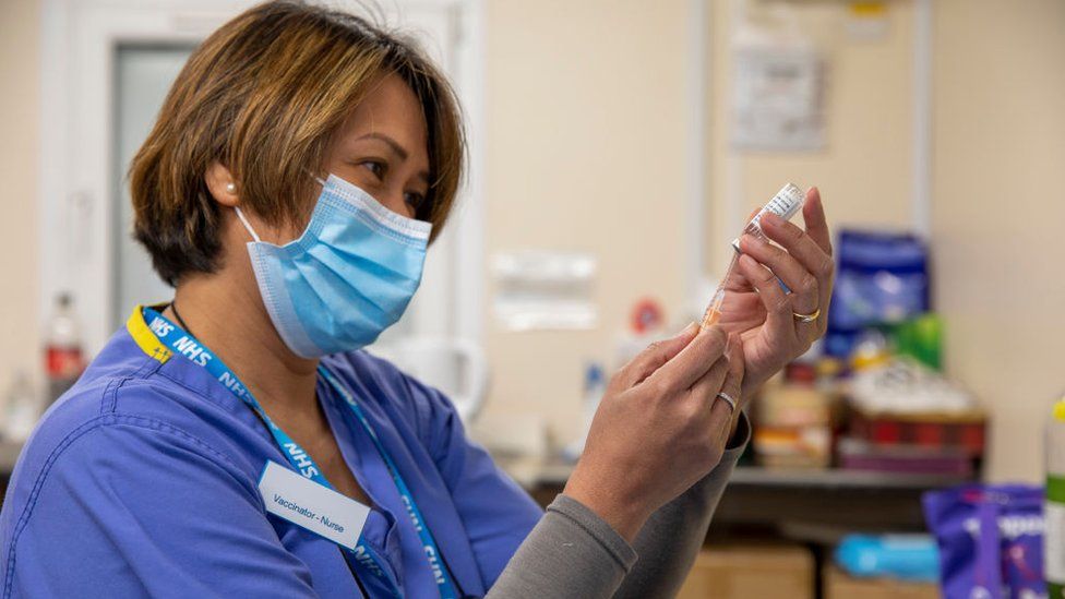 NHS nurse doing a vaccine