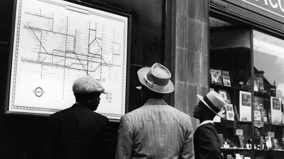 A group of Jamaican immigrants new to London scrutinise a map of the Underground